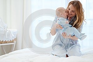 Happy middle aged mother with her child in a bed