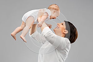 Happy middle-aged mother with little baby daughter