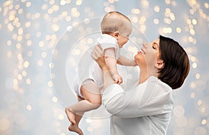 Happy middle-aged mother with little baby daughter