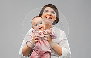 Happy middle-aged mother with little baby daughter