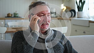 Happy middle aged senior man talking on smartphone with family friends. Older mature grandfather with cell phone talking