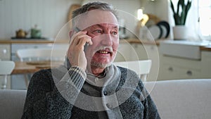 Happy middle aged senior man talking on smartphone with family friends. Older mature grandfather with cell phone talking