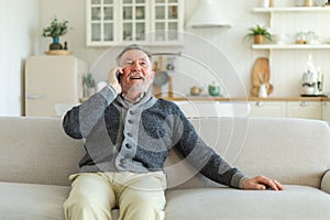 Happy middle aged senior man talking on smartphone with family friends. Older mature grandfather with cell phone talking