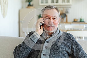 Happy middle aged senior man talking on smartphone with family friends. Older mature grandfather with cell phone talking