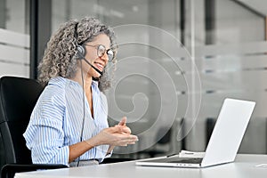 Happy middle aged woman call center customer support agent working in office.