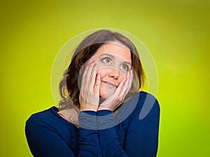 Happy, middle aged woman looking upwards daydreaming