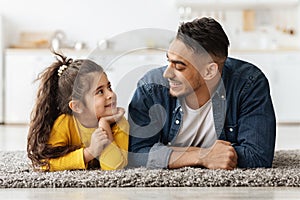 Happy Middle Eastern Family Dad And Daughter Relaxing Together On Floor
