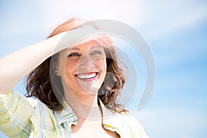 Happy midle aged woman protecting from sun