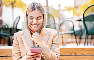 Happy millenial woman smiling over open face mask after lockdown reopening - New normal technology concept by confident girl