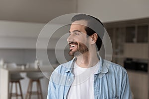 Happy millennial 30s man in casual home head shot portrait
