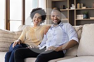 Happy millennial African American couple of homeowners