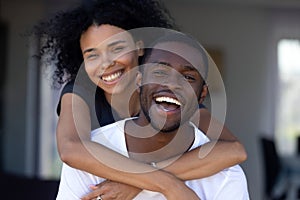 Happy millennial black couple laughing having fun outdoors, portrait