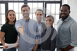 Happy millennial business group leader giving hand for shake