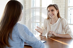 Happy millennial female job seeker making self-presentation to employer.