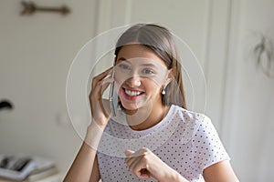Happy millennial female talk on smartphone call