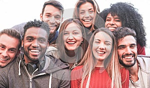 Happy millennial friends from diverse cultures and races taking selfie for social network story - Youth and friendship concept