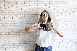 Happy millennial girl having fun indoors. Portrait of young woman with diastema gap between teeth. Beautiful smile. Minimalistic i