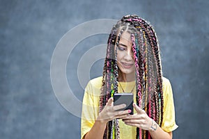 Happy millennial girl using mobile phone app for social media
