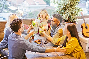 Happy millennials friends toasting and celebrating together