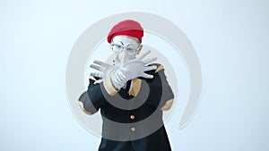 Happy mime with expressive face dancing and gesturing against white background