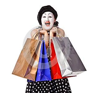 Happy mime in spotty dress holding shopping bags