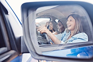 Happy, mirror and friends with women in car driving for road trip, vacation and transportation. Summer break, travel and