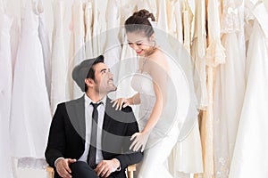 Happy mix race wedding concept, Caucasian groom with beard  kiss beautiful Asian bride hand with love, passion, tenderness in