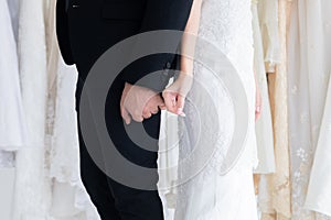 Happy mix race wedding and shopping concept, couple hold hand together love and passion in fitting room with copy space, beautiful