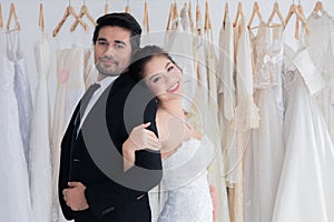 Happy mix race wedding and shopping concept, couple hold hand together love and passion in fitting room with copy space, beautiful