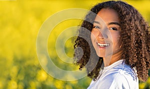 Happy Mixed Race African American Teenager Woman in Yellow Flowers