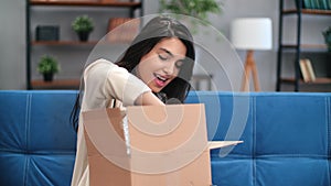 Happy mixed race brunette woman unpacking cardboard box marketplace order online shopping sale