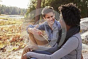 Happy mixed race couple talking in the countryside