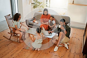 A happy mixed race family of five relaxing in the lounge and being playful together. Loving black family bonding with