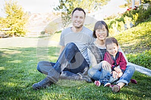 Happy Mixed Race Family Having Fun Outside on the Grass