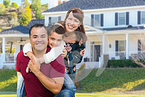 Happy Mixed Race Family Portrait In Front of Their House