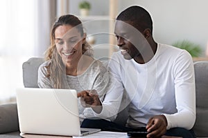 Happy mixed race family spouse making monthly budget calculations. photo