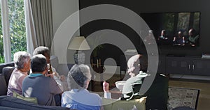 Happy mixed race senior couple and african american friends drinking beer and having fun