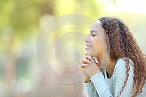 Happy mixed race woman meditating outdoors