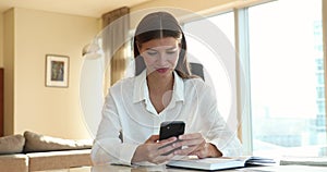 Happy mobile phone user woman reading text message on smartphone