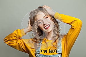 Happy model girl smiling on gray background