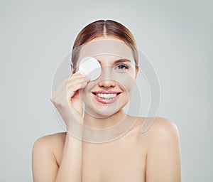 Happy model woman with cotton pads. Skincare, facial treatment,