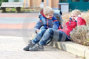 Happy modern boys with mobile phone