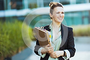 happy modern business woman near office building