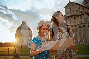 Happy modern mother and daughter with map having excursion