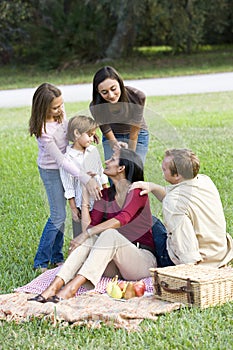 Happy modern multicultural family enjoying picnic