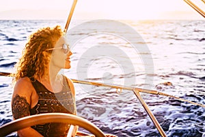 Happy modern and trendy caucasian woman portrait enjoy trip and tour on sail boat in summer holiday vacation leisure activity -