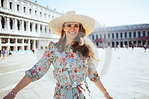 Happy modern woman in floral dress exploring attractions