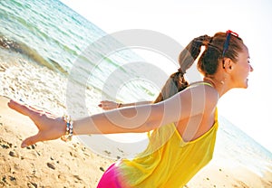 Happy modern woman on seacoast in evening rejoicing