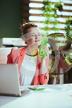 happy modern woman worker in modern green office in red jacket