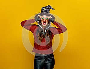 Happy modern woman on yellow background having fun time